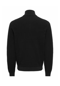 Pull noir en maille à col roulé et manches longues, présenté de dos avec un ourlet et des poignets côtelés.