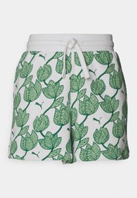 Valkoiset shortsit, joissa on vihreä kukkakuvio ja lehden kuvasto, elastinen vyötärönauha ja valkoinen naru edessä.