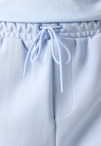 BOSS HEADLO - Spodnji deli trenirk - light blue