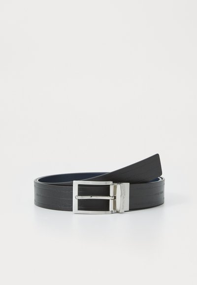 Black belt made of smooth leather with a silver metal buckle. Features embossed branding along the strap, showcasing a sleek, minimalist design.