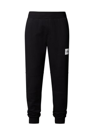 Czarne dresy z miękkiego materiału o zwężającym się kroju, z prążkowanym paskiem w talii i małą naszywką logo z przodu.