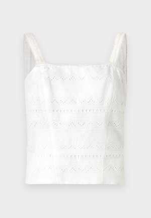 Biała bawełniana kamizelka na ramiączkach z cienkimi paskami, z haftowanymi wzorami i wycięciami. Gładka tekstura, dopasowany krój.
