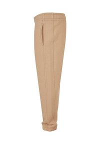 Beige Jogginghose mit elastischem Bund und Bündchen, seitlichen Eingrifftaschen und gesteppten Details entlang des Beins.