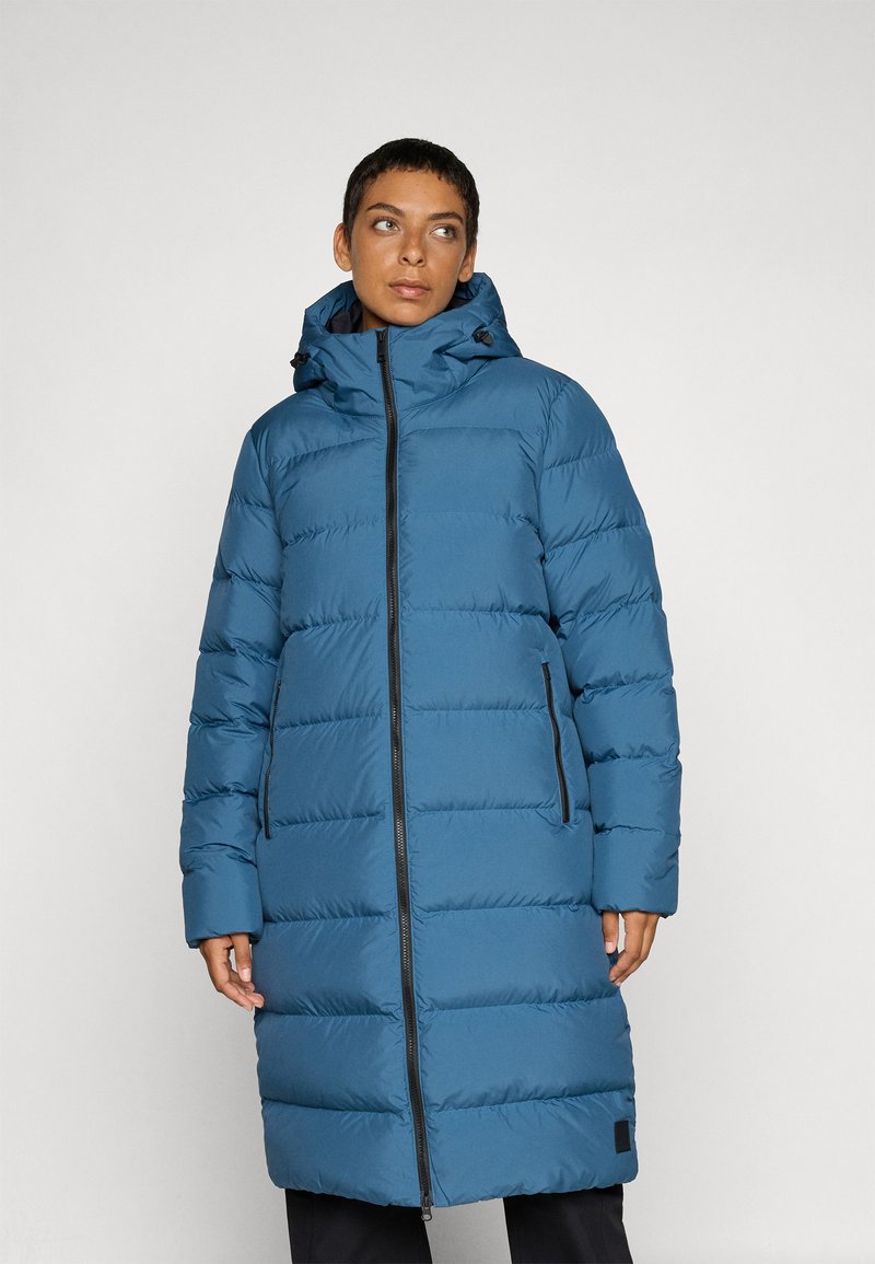 Long blue puffer coat with horizontal padding, zip closure, and hood. Features two side pockets and a slightly flared silhouette. Smooth texture.