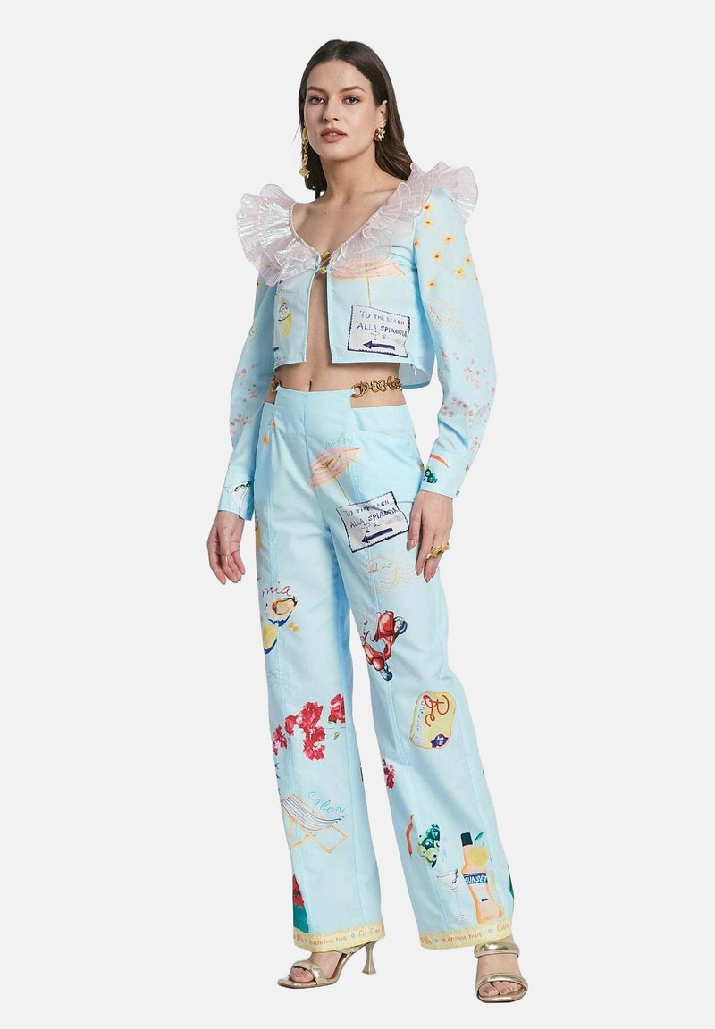 Light blue cropped jacket with ruffled neckline, zip closure, and colorful prints. Matching wide-leg pants feature various illustrations and pockets.