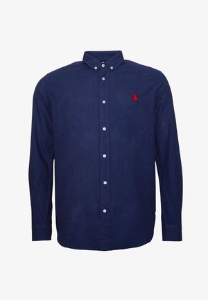 Marineblaue Langarmbluse aus Baumwolle mit einem Button-Down-Kragen. Verfügt über ein rotes gesticktes Logo und weiße Knöpfe entlang der Vorderseite.