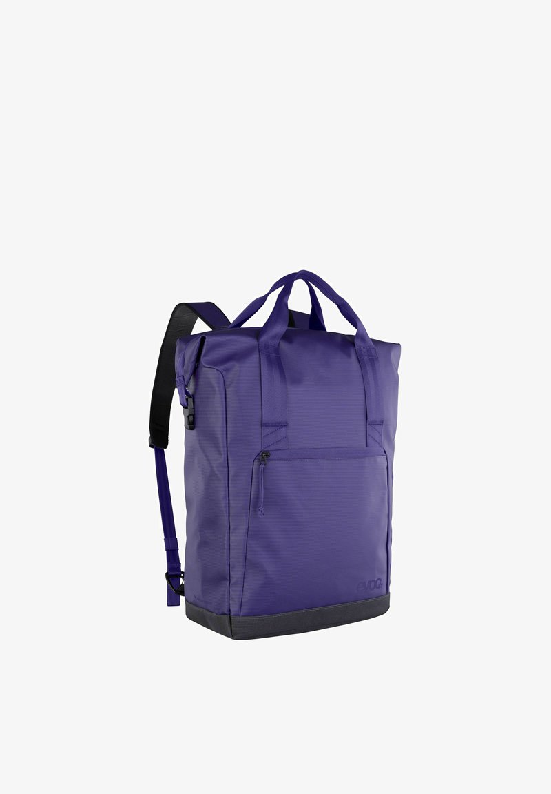 Borsa tote viola realizzata in tessuto resistente, dotata di due manici superiori e una tracolla singola. Include una tasca frontale con cerniera e una base testurizzata.