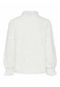 Blouse blanche texturée à manches longues avec un motif floral subtil, poignets froncés, col à volants, vue de dos.