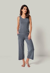 Gray ribbed tank top and wide-leg pants set in soft fabric, featuring a scoop neckline and side pockets for comfort and practicality.