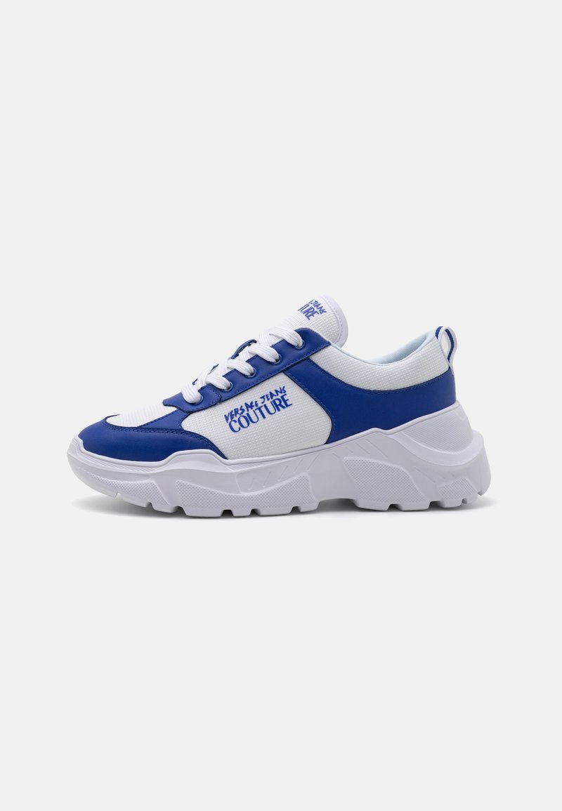 Blue and white sneakers with a chunky white sole, fabric panels, and logo detailing. Features laces and reinforced heel for support.