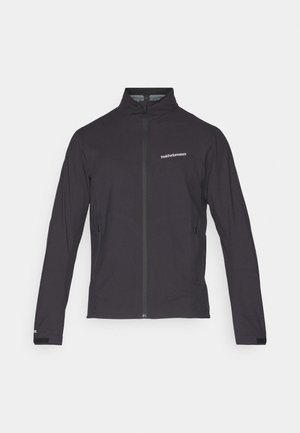 Svart lett jakke med høy krage, hel glidelås, glidelåslommer på sidene og en logo på venstre bryst. Glatt tekstur.