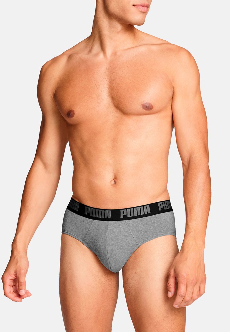 Graue Baumwollunterhosen mit einem schwarzen elastischen Bund, der das "PUMA"-Logo zeigt. Taillierte Passform mit einer glatten Textur.