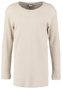 Beige långärmad topp med ribbad textur, rund hals och manschetter. Enkel design, klassisk passform, lämplig för avslappnad användning.