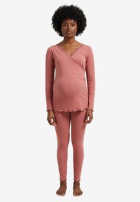 Maternity pajama set in soft pink, featuring a wrap top with lace trim and long sleeves, paired with polka dot leggings in matching color.
