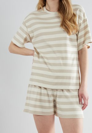 Beige och krämfärgade randiga kortärmade toppar och matchande shorts gjorda av ribbad tyg, med avslappnad passform och rundad fåll.