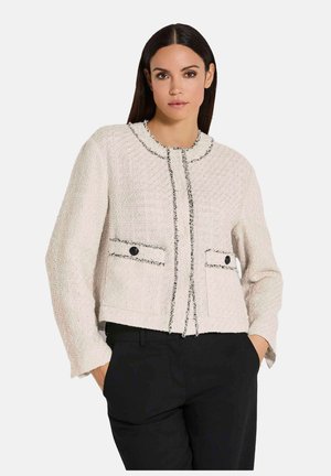 Korte, crèmekleurige tweedjas met een ronde halslijn, zwarte afwerking, twee voorzakken met knopen en een cropped ontwerp.