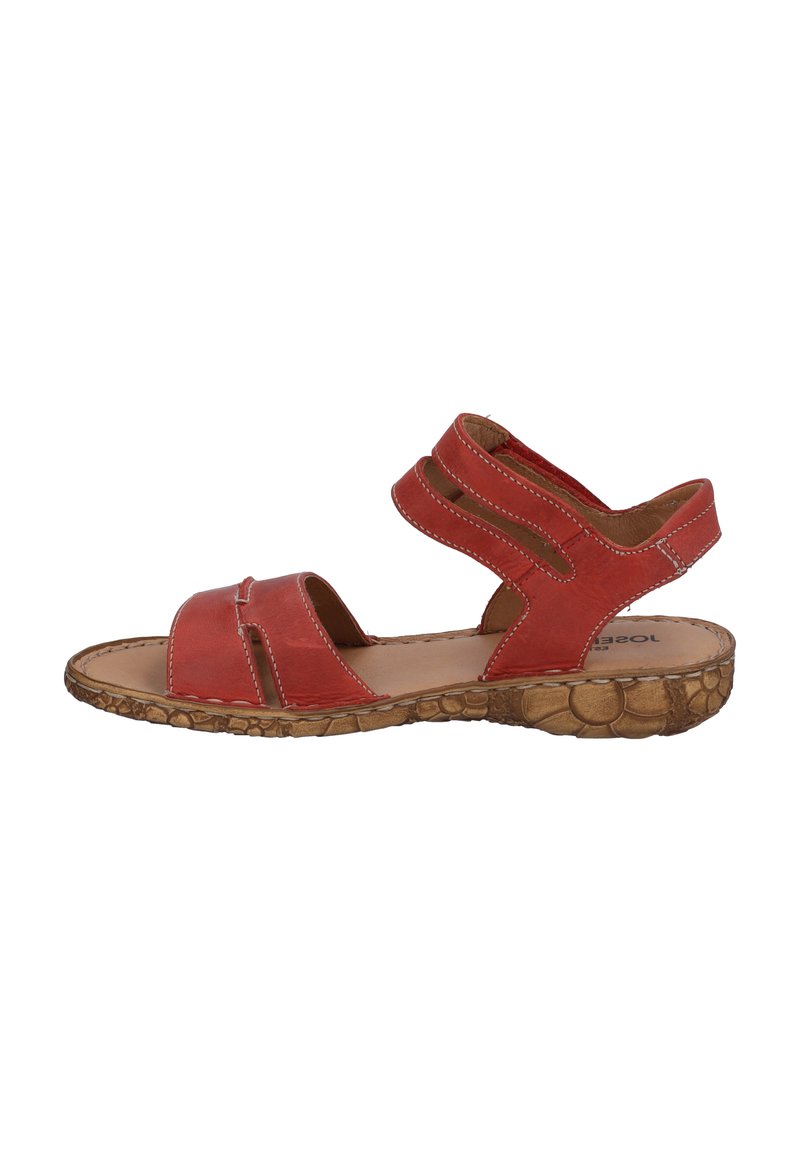 Red leather sandal with two wide straps and a textured, patterned outsole. Features open toe design and padded insole for comfort.