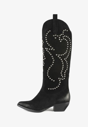 Black suede cowboy boots with a pointed toe, featuring silver stud accents in a swirling pattern, and a stacked heel.