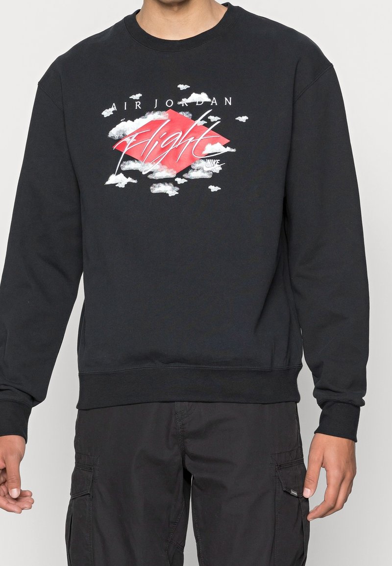 Black sweatshirt with a crew neck, featuring a colorful graphic design of clouds and a diamond with "AIR JORDAN Flight" in white letters.