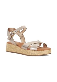 Wedge sandal with metallic gold straps, woven jute sole, and a padded footbed. Features an adjustable ankle buckle for secure fit.