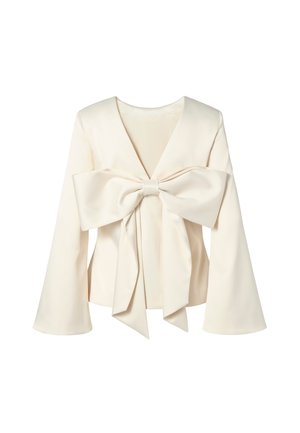 White long-sleeve blouse featuring a deep V-neck and a large bow accent at the front, crafted from smooth fabric with a structured design.