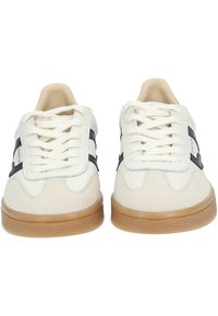 White leather and beige suede sneakers with white laces, navy accents, rubber sole, and subtle logo detail on the side. Rounded toe design.