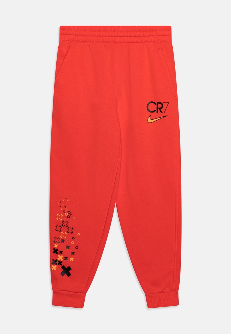 Rode trainingsbroek van zacht materiaal, met zwarte "CR7" en Nike-logo's, en een kleurrijk grafisch patroon nabij de zoom. Elastische tailleband.