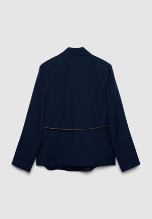 Navy blazer with a tailored fit, featuring a back vent, long sleeves, and a contrasting thin horizontal seam across the back.