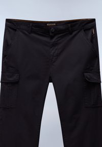Black cargo pants featuring a straight cut, multiple pockets, and a textured fabric with a buttoned fly and stitched detailing.
