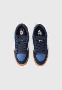 Navy and light blue suede sneakers with a gum sole, featuring white accents, round toe, and black laces, designed for casual wear.