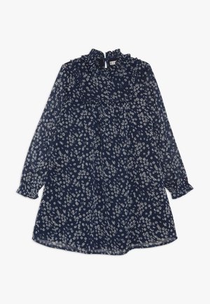 Robe bleu marine à manches longues avec motif floral blanc, col montant plissé et taille froncée.