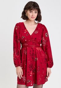Red floral dress with a V-neck, long puff sleeves, and an elastic waist. Features intricate patterns and a gathered skirt.