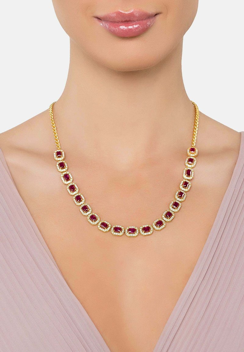 Gold-tone necklace with rectangular red stones surrounded by clear accents, featuring a braided chain design for a textured finish.