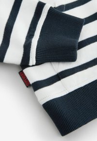 Marinblå och vit randig sweatshirt med ribbad struktur, med en liten röd "Superdry"-etikett på sidan.
