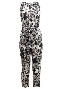 Combinaison noire sans manches avec motif floral beige et blanc, encolure ronde et ceinture en tissu nouée à la taille.
