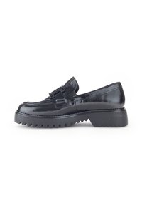Black patent leather loafer with a decorative buckle, round toe, and chunky, ridged sole for enhanced grip and durability.