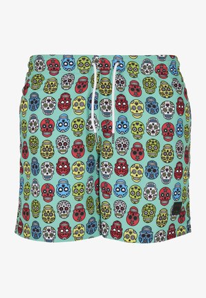 Zwemshorts met een mintgroene achtergrond, versierd met een patroon van kleurrijke schedels in rood, blauw, groen, geel en zwart. Elastische tailleband met trekkoord.