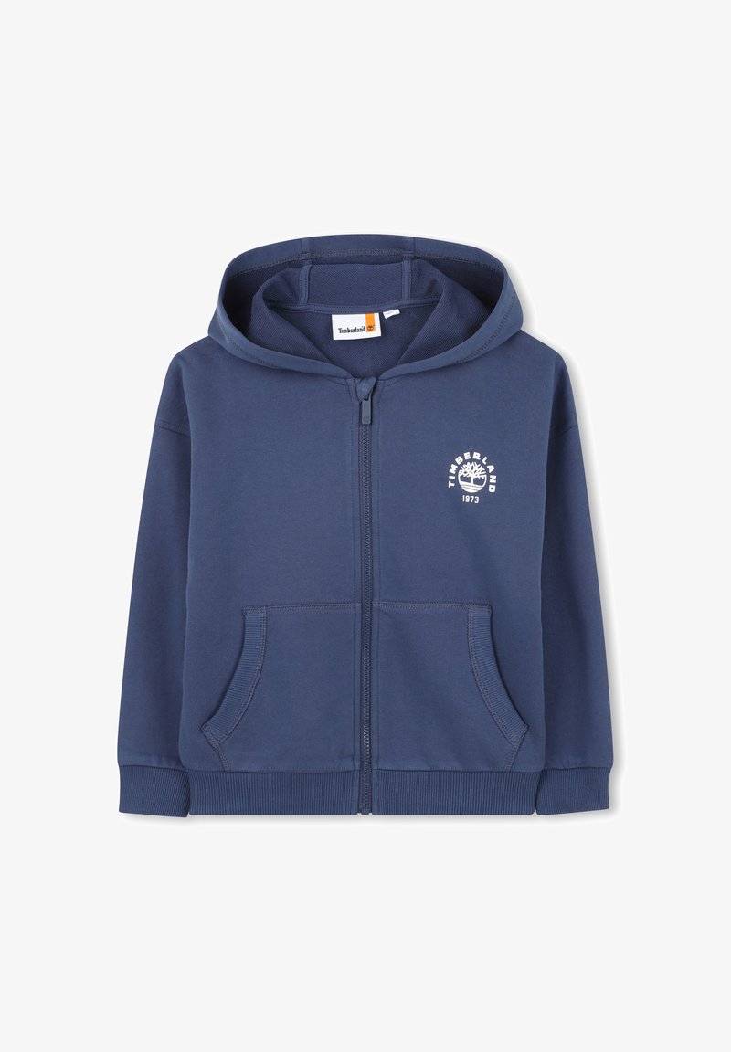 Sweat à capuche bleu marine zippé avec poches avant, poignets et ourlet côtelés, capuche et logo Timberland blanc avec arbre et "1973" sur la poitrine.