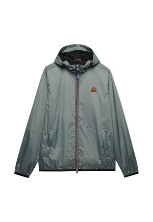 Light grey hooded windbreaker jacket with front zipper, two side pockets, elastic cuffs, and a small colorful logo on the chest.