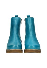 Bottes en cuir turquoise à la cheville avec une texture lisse, fermetures éclair de chaque côté et une semelle en caoutchouc brun clair.