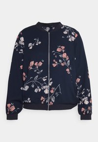 Giacca bomber floreale con sfondo blu navy, caratterizzata da motivi di fiori rosa e bianchi, chiusura a zip e polsini e orlo a coste.