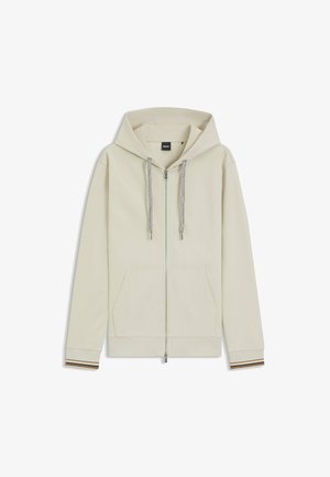 Lavet af en let cremefarvet bomuldsblanding, har denne lynlås hoodie en stor hætte, to forlommer og ribbede manchetter med brune striber.