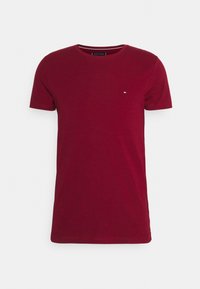 Plain dark red short-sleeve crew neck T-shirt with a small Tommy Hilfiger logo on the left chest.