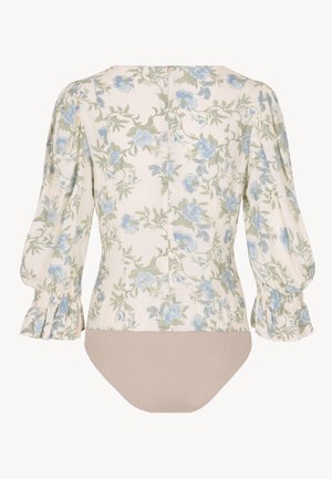 Bloemenbodysuit met blauwachtige bloemen op een licht crèmekleurige achtergrond. Puffmouwen en geplooide details bij de manchetten. Effen beige ondergedeelte.