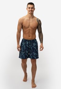 Zwemshorts voor heren in marineblauw met een patroon van palmbladeren, elastische tailleband en koord. Gemaakt van lichtgewicht stof, ideaal voor wateractiviteiten.