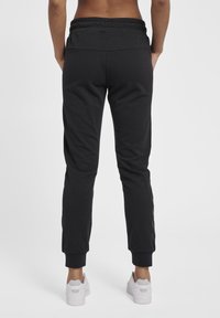 Hummel HMLNONI  - Trainingsbroek - black