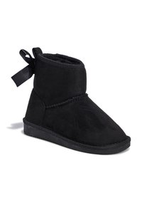 Botines de ante negros con un suave forro interior, puntera redondeada y un lazo de satén negro decorativo en la parte posterior. Suela de goma plana con agarre texturizado.