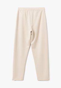 Beige Leggings mit einem elastischen Bund, aus weichem, glattem Stoff. Eng anliegendes Design mit geradem Schnitt und ohne Muster oder Akzente.