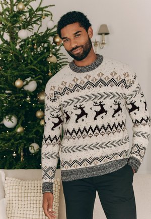 Chunky knit sweater in cream with brown and black reindeer and geometric patterns. Ribbed cuffs and neckline in dark gray.