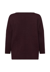 Bordo pleten pulover s sproščenim krojem, širokim izrezom in dolgimi rokavi. Ima navpično šiv na sredini hrbta.